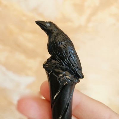 Carved wooden hair stick with black raven
