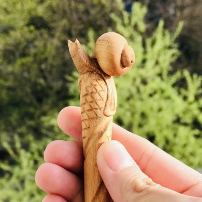 Carved wooden hair stick with snail