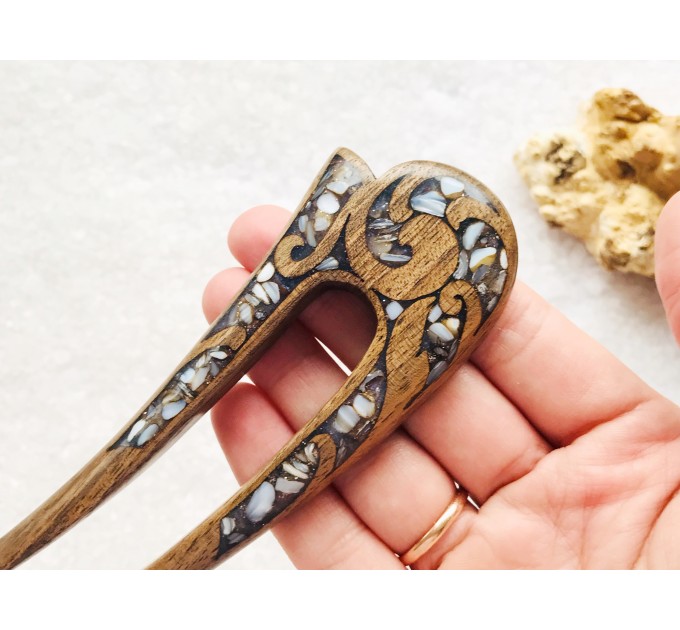 Wooden hair fork with gray stones 