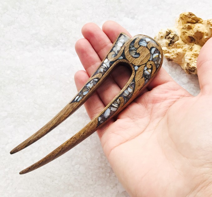 Wooden hair fork with gray stones 